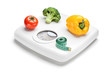 Vegetables and measuring tape on a weight scale Vegetables and measuring tape on a weight scale