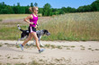 Photo: Walking a dog in summer nature, woman runner Walking a dog in summer nature, woman runner