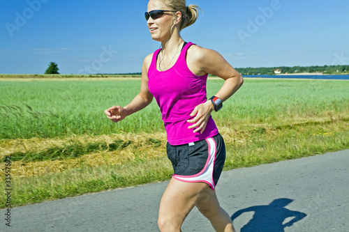 Photo: Running woman with music in summer nature Running woman with music in summer nature