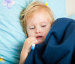a sick girl is measuring the temperature