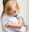 a mother is holding a sick girl.