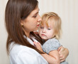 a mother is holding a sick girl.