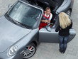 Mechanic explaining maintenance costs to customer outdoors