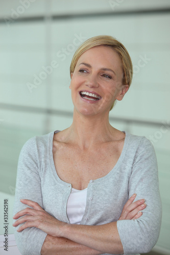 Photo: Woman laughing with her arms crossed Woman laughing with her arms crossed