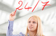 Woman writing "24/7" on the screen