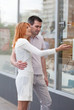 married couple to stand at a shop show-window.