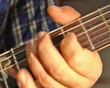 close-up playing at electric guitar