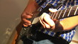man playing at electric guitar