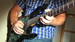 man playing at electric guitar