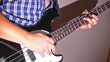 man playing at bass guitar