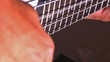 close-up playing at bass guitar