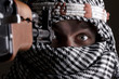 Scared aimed middle eastern man