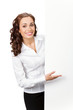 Smiling businesswoman showing blank signboard, isolated