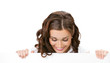 Smiling businesswoman showing blank signboard, isolated