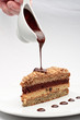 Photo: A piece of fresh baked delicious sponge-cake with chocolate sauc A piece of fresh baked delicious sponge-cake with chocolate sauc