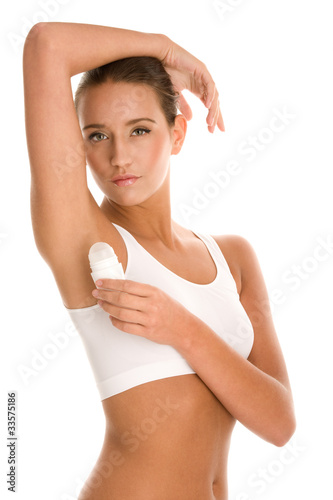 Photo: Woman using deodorant Woman using deodorant
