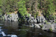 Fisherman cathing fish sitting on the rocks in river