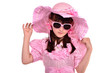 Portrait of lovely girl wearing pink dress, hat and glasses