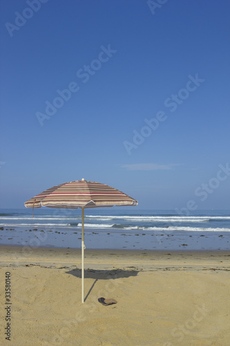 Photo: Beach Umbrella and Sandals; copyspace Beach Umbrella and Sandals; copyspace