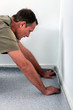 Man laying carpet