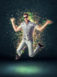 Jumping smiling young man on glowing abstract background