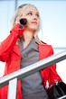 Beautiful woman in red jacket standing on the shop Beautiful woman in red jacket standing on the shop