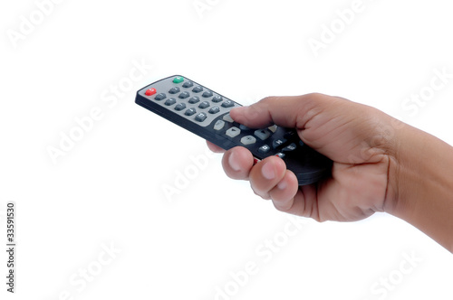 Photo: male hand holding a remote controller male hand holding a remote controller
