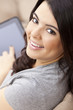 Happy Hispanic Woman Using Tablet Computer