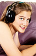 Young Girl enjoys listening music in headphones