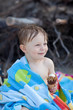 Portrait of an adorable toddler eating ice cream on a beach