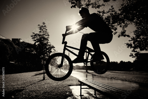 Photo: boy jumping over bench on bmx boy jumping over bench on bmx