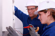 a young woman working on an electricity meter
