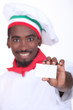 young black Italian cook showing a professional card