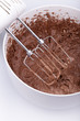 studio-shot of kneading dough for a cake with a a mixer.