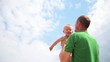 Father tossing baby on sky background Father tossing baby on sky background