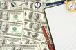 stethoscope and dollars with notebook stethoscope and dollars with notebook