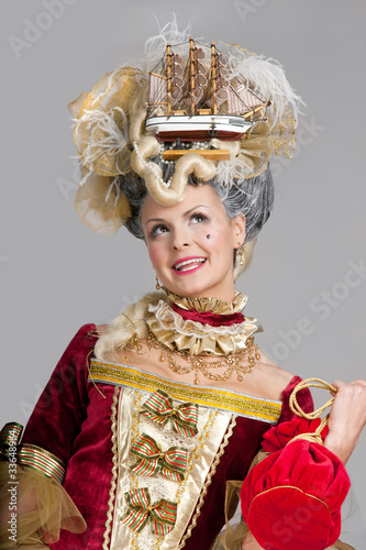 Photo: Smiling woman in 18th century style red dress Smiling woman in 18th century style red dress