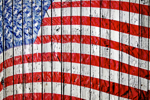 Photo: Old Painted American Flag on Dark Wooden Fence Old Painted American Flag on Dark Wooden Fence