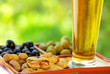 beer glass with peanuts and olives