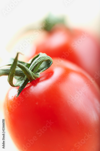 Photo: cherry tomatoes on a white background, shallow deep of field cherry tomatoes on a white background, shallow deep of field