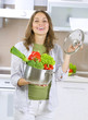 Beautiful Young Woman cooking fresh Vegetables. Dieting Concept Beautiful Young Woman cooking fresh Vegetables. Dieting Concept