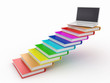 Staircase from books and laptop on the top