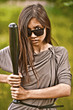 Portrait of young aggressive woman with bat