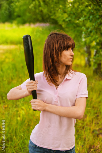 Photo: portrait of young woman with bat portrait of young woman with bat