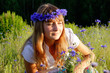 girl among the cornflowers and daisies in a meadow