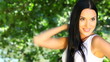 brunette with a beautiful face in park