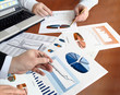 Closeup of hands with financial  charts  at business meeting