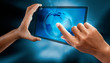 A woman use a digital tabler, PDA, to see a wold map.