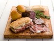 focaccia with ham salami and cheese over cutting board focaccia with ham salami and cheese over cutting board