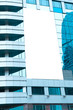 blue glass wall with blank placard of skyscraper